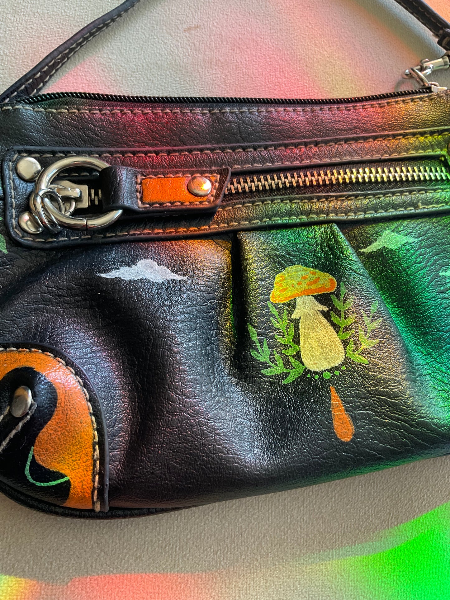 Black wristlet handpainted with orange white and green